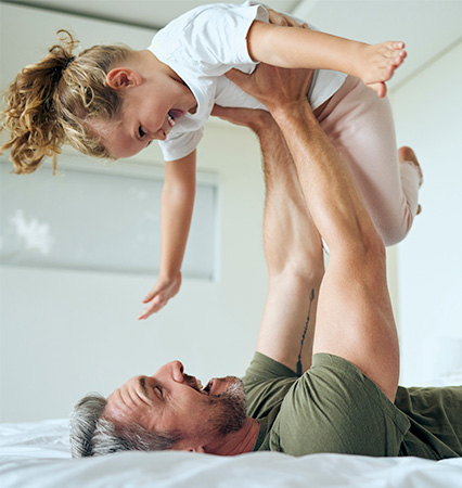 Happy man carrying a little girl - aesthetic services south jordan